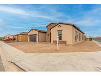 Attractive single-story home with brick accents, a two-car garage, and low-maintenance landscaping at 742 E Watermelon Ln, Queen Creek, AZ 85140