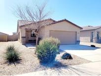 Charming single-story home with a tile roof and a well-maintained front yard with desert landscaping at 1061 W Palo Verde Ave, Coolidge, AZ 85128