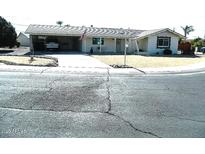 Charming single-story home featuring a carport, desert landscaping, and a welcoming front entrance at 10612 N 102Nd Dr, Sun City, AZ 85351