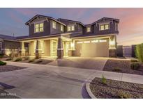 Stunning two-story home with a large driveway and manicured landscaping at 10635 E Tesla Ave, Mesa, AZ 85212