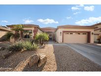 Charming single-story home featuring manicured landscaping, a two-car garage, and a welcoming entrance at 11122 N 165Th Ave, Surprise, AZ 85388