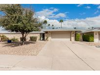 Charming single-story home with a two-car garage, desert landscaping, and a well-maintained yard at 12810 W Ashwood Dr, Sun City West, AZ 85375