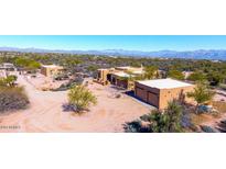 Tan home exterior with desert landscaping and a large lot and mountain views at 14925 E Morning Vista Ln, Scottsdale, AZ 85262