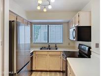 Bright kitchen featuring stainless steel appliances and a window over the sink at 19820 N 13Th Ave # 241, Phoenix, AZ 85027