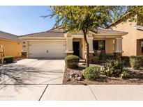 Charming single-story home with a well-manicured front yard and a two-car garage at 4189 E Sandy Way, Gilbert, AZ 85297