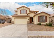 Two-story beige home featuring a two-car garage and desert landscaping under a partly cloudy sky at 4255 E Cloudburst Ct, Gilbert, AZ 85297