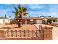 Charming single-story home with well-maintained desert landscaping and a brick fence at 4601 S 21St St, Phoenix, AZ 85040