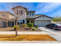 Charming two-story home with a well-manicured front yard and a two car garage on a sunny day at 5513 S Coyote Cyn, Mesa, AZ 85212