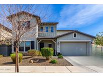 Charming two-story home featuring a gray painted exterior, well-kept landscaping, and an attached two-car garage at 5513 S Coyote Cyn, Mesa, AZ 85212