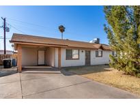 Modest single-story home featuring a covered carport and neutral exterior paint at 658 S Sycamore St, Mesa, AZ 85202