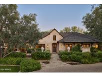 Charming single-Gathering home with a stone pathway, manicured landscaping, and a wood-shingled roof at 6737 E Taza Way, Paradise Valley, AZ 85253