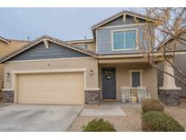 Charming two-story home featuring a covered porch, a two-car garage, and inviting curb appeal at 10822 W Taylor St, Avondale, AZ 85323
