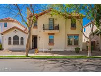 Charming two-story home with a balcony and well-manicured front yard at 1422 S Colt Dr, Gilbert, AZ 85296