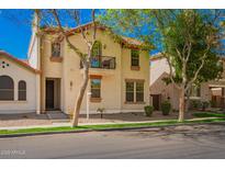 Inviting two-story home with a balcony, landscaped front yard, and great curb appeal at 1422 S Colt Dr, Gilbert, AZ 85296