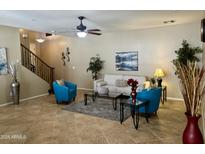 Inviting living room featuring stylish furniture, neutral walls, ceiling fan, and tiled floors at 1422 S Colt Dr, Gilbert, AZ 85296