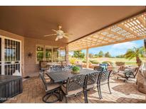 Inviting covered patio with golf course views, seating, and an outdoor dining area at 17637 N Goldwater Dr, Surprise, AZ 85374
