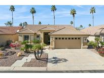 Charming single-story home featuring a tile roof, desert landscaping, and a two-car garage at 3362 N 159Th Ave, Goodyear, AZ 85395