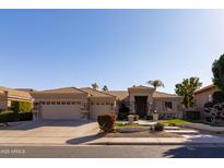 Charming single-story home with well-maintained front yard and desert landscaping and three-car garage at 3631 S Greythorne S Way, Chandler, AZ 85248