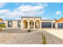 Charming home featuring an arched entry and xeriscaped front yard for low-maintenance appeal at 3743 W Hartford Ave, Glendale, AZ 85308