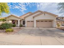 Charming single-story home featuring a well-manicured front yard, a two car garage, and beautiful desert landscaping at 4521 W Hopi Trl, Laveen, AZ 85339