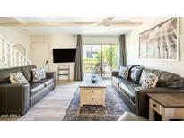 Comfortable living room with leather couches and a view to the backyard at 4620 N 68Th St # 117, Scottsdale, AZ 85251