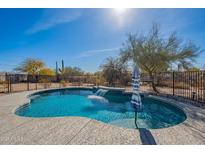 Backyard pool with a relaxing waterfall feature for enjoying warm days under the sun at 532 N 102Nd Pl, Mesa, AZ 85207
