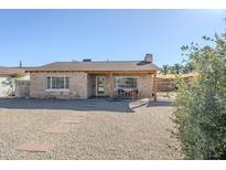 Charming single-story home with a stone facade, covered porch, and desert landscaping at 541 W Edgemont Ave, Phoenix, AZ 85003