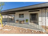 Charming front porch with seating area and decorative metal railing, enhancing the curb appeal at 5910 E Colby St, Mesa, AZ 85205