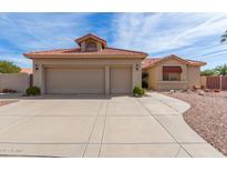 Charming single-story home with a tile roof and attached two-car garage at 9519 E Indiana Ct, Sun Lakes, AZ 85248