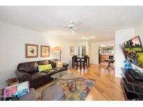 Inviting living room featuring a leather sofa, area rug, and an adjacent dining area at 9990 N Scottsdale Rd # 1006, Paradise Valley, AZ 85253