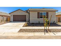 Charming single-story home with a well-manicured front yard and a two-car garage at 1187 E Ridgerock St, Casa Grande, AZ 85122