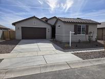 Charming single-story home with a well-manicured front yard and a two-car garage at 1187 E Ridgerock St, Casa Grande, AZ 85122