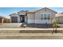 Charming single-story home with a well-manicured front yard and inviting entrance, creating a welcoming curb appeal at 1191 E Ridgerock St, Casa Grande, AZ 85122