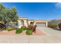 Charming single-story home showcasing desert landscaping, a tile roof, and a two-car garage at 12752 W Junipero Dr, Sun City West, AZ 85375