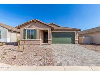 Charming single-story home featuring a green garage door, desert landscaping, and a paver driveway at 13242 W Hackamore Dr, Peoria, AZ 85383