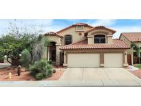 Charming two-story home with a red tile roof, a two-car garage, and beautiful desert landscaping at 14009 N 30Th St, Phoenix, AZ 85032