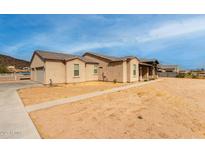 Stunning exterior view of a modern single-story home with a tile roof and desert landscaping at 1444 W Gail Rd, San Tan Valley, AZ 85144