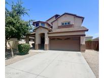 Two-story home showcasing a brown garage door, neutral stucco exterior and manicured landscaping at 15232 W Edgemont Ave, Goodyear, AZ 85395