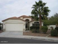 Charming single-story home featuring desert landscaping, a two car garage and a welcoming front entrance at 1870 N 128Th Dr, Avondale, AZ 85392