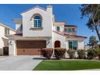 Charming two-story home featuring a red tile roof, white stucco, arched entry, and landscaped front yard at 2300 W Sunrise Pl, Chandler, AZ 85248