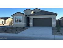 Charming single story home with a neutral color palette, well-manicured landscaping and a two car garage at 39965 W Venture Rd, Maricopa, AZ 85138