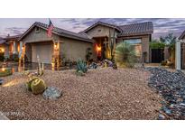 Charming single-Gathering home featuring an inviting desert landscape with decorative rock and various cacti at 4216 E Desert Marigold Dr, Cave Creek, AZ 85331