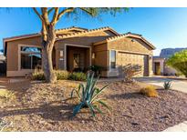 Charming single-story home featuring desert landscaping and a two-car garage in a sunny, tranquil neighborhood at 4267 S Strong Box Rd, Gold Canyon, AZ 85118