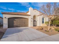 Charming home features a two-car garage, gated front entrance, and a well-maintained, low maintenance yard at 518 E Laddoos Ave, Queen Creek, AZ 85140