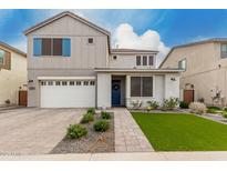 Charming two-story home featuring a two-car garage, landscaped front yard, and stylish architectural details at 5281 S Red Rock St, Gilbert, AZ 85298