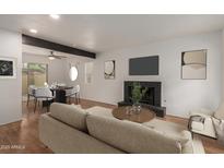 Inviting living room boasts a fireplace and dining area with access to outdoor patio at 6542 N 7Th Ave # 30, Phoenix, AZ 85013