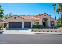 Charming single-story home with a three-car garage and desert landscaping at 9246 N 108Th St, Scottsdale, AZ 85259