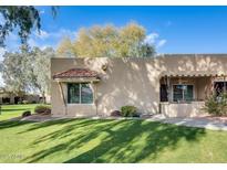 Charming single-story home with well-maintained lawn, desert landscaping, and covered front porch at 14300 W Bell Rd # 142, Surprise, AZ 85374