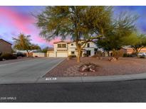 Two-story home featuring a three-car garage, desert landscaping, and a charming pathway to the entrance at 31301 N Sunflower Way, San Tan Valley, AZ 85143