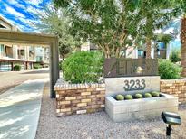 View of desert landscaping at community entrance with address and building name, under a bright sky at 3233 N 70Th St # 1006, Scottsdale, AZ 85251